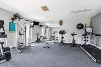 the gym at the apartments with weights and cardio equipment